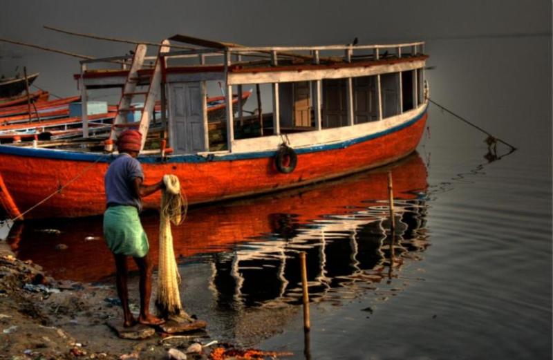 fish catcher on the shore of the Ganges River