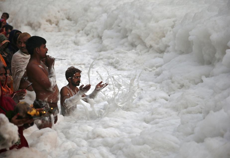 worship the Sun god Surya in the polluted waters of the river Yamuna