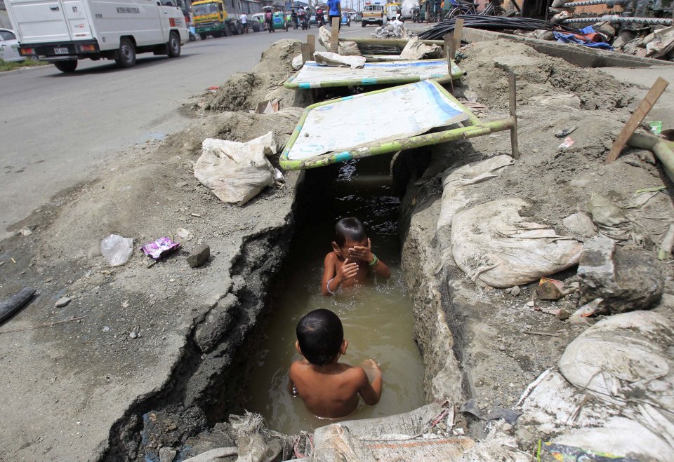 in an open drainage ditch in Manila, Philippines.