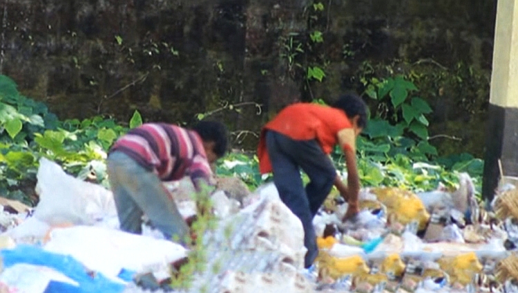 tribal children eating from garbage