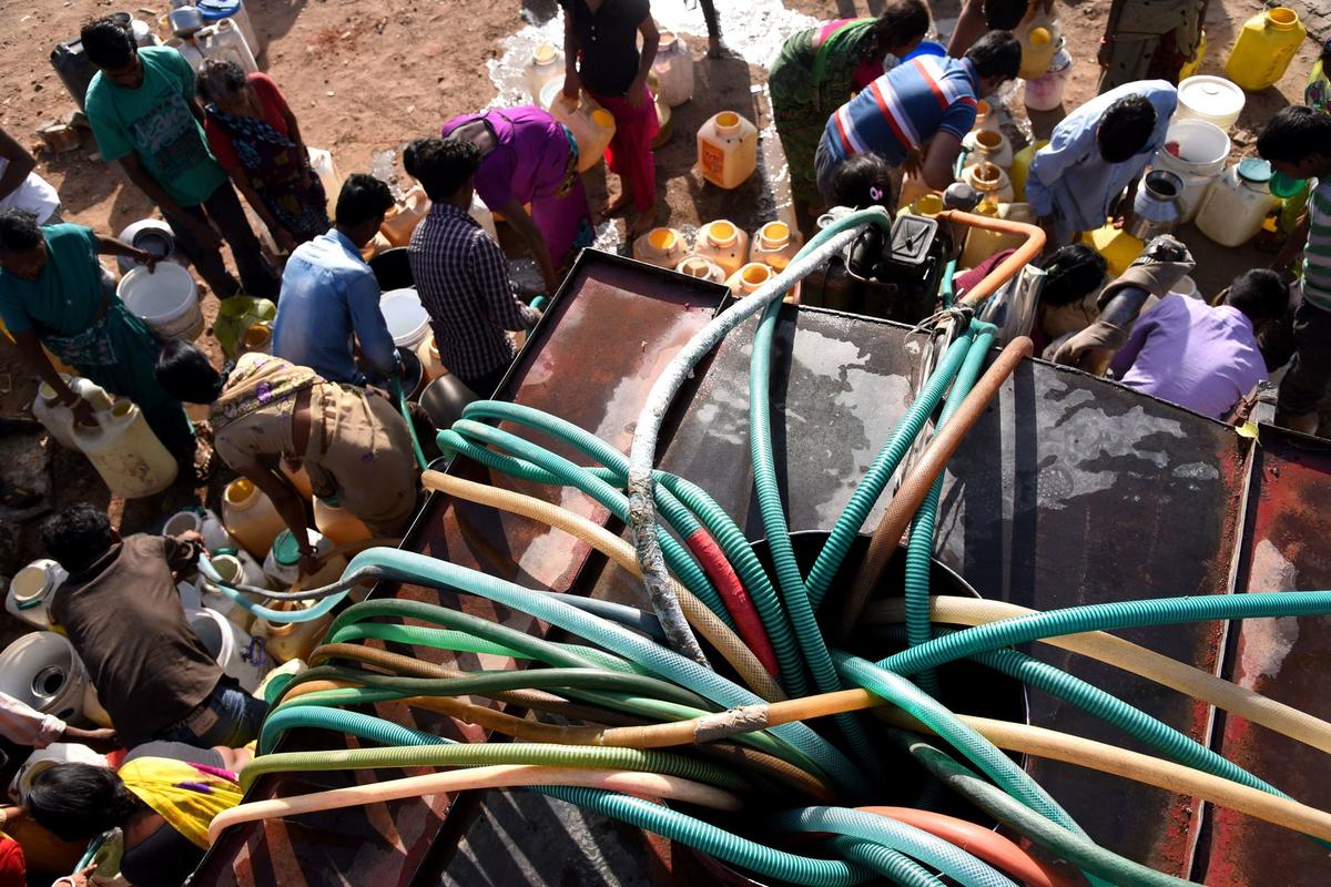 drinking water from a tanker in Bhopal, India