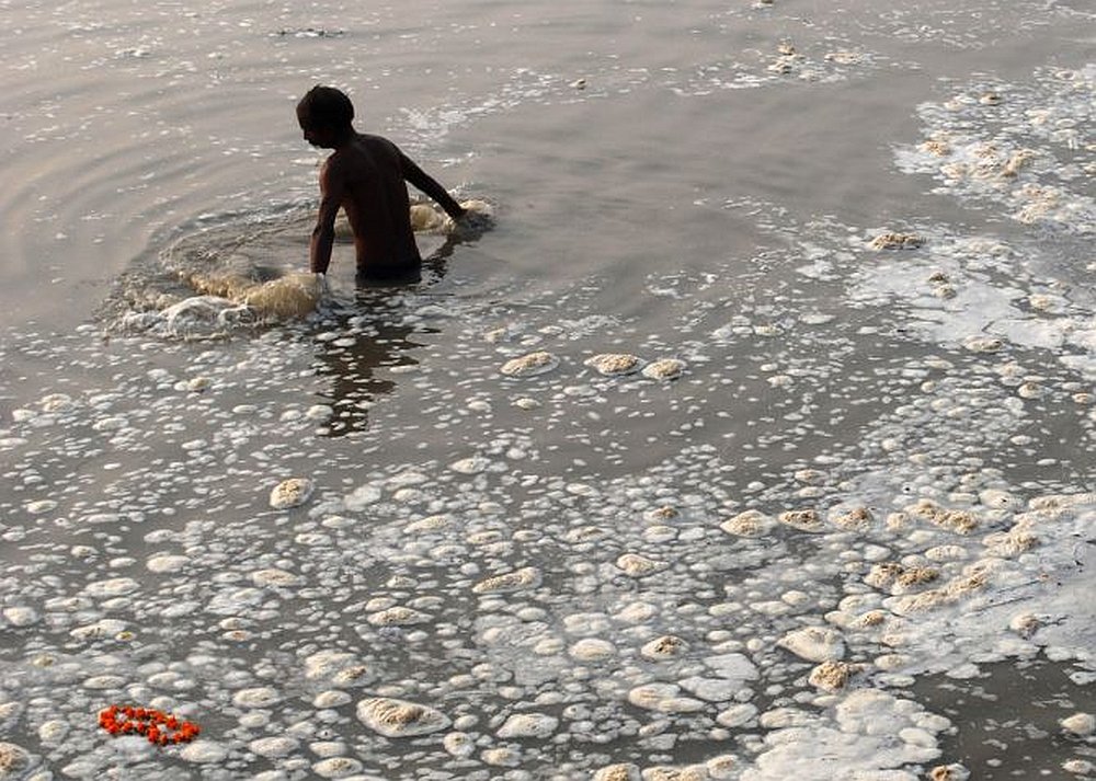 Devotee takes a holy dip in the polluted Sangam