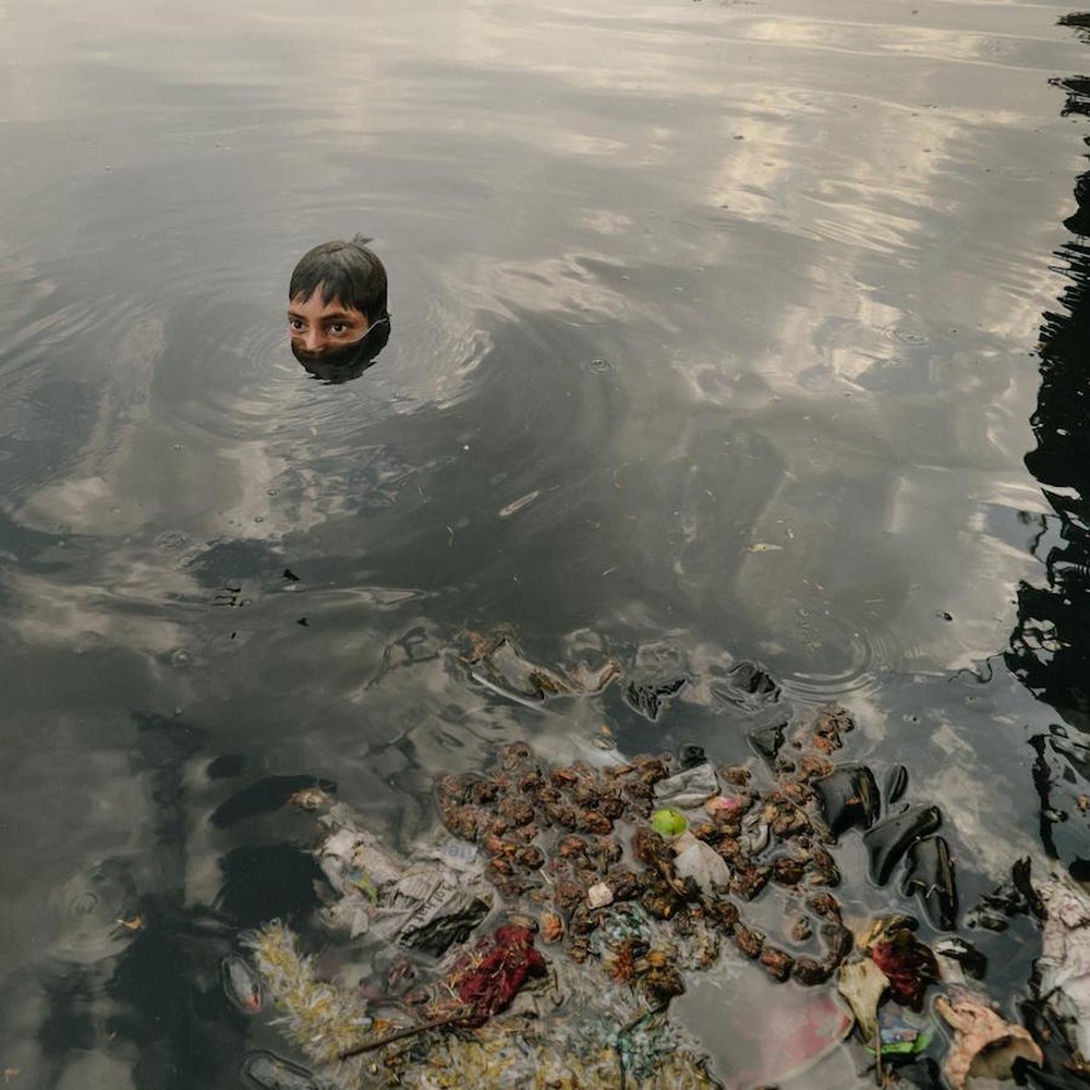 Children search the polluted Yamuna River