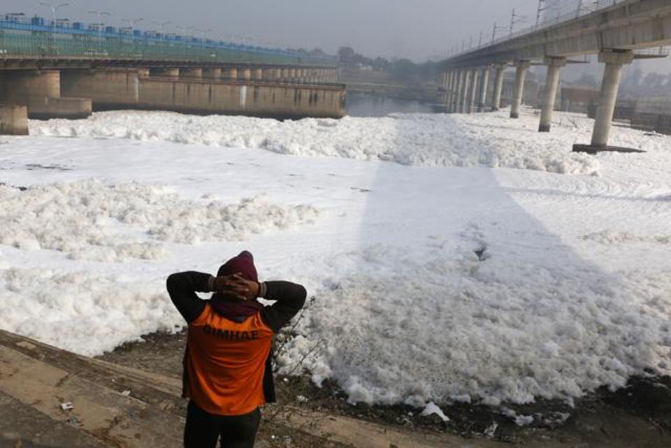 Foam-coated surface of river Yamuna, the longest and second largest tributary of holy Ganges