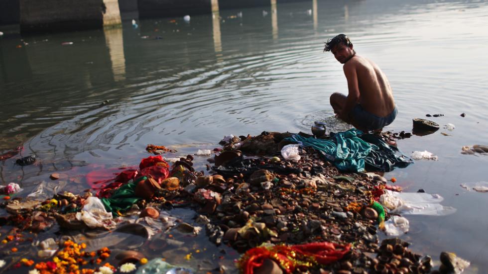 devotee bathes in the Yamuna river in New Delhi