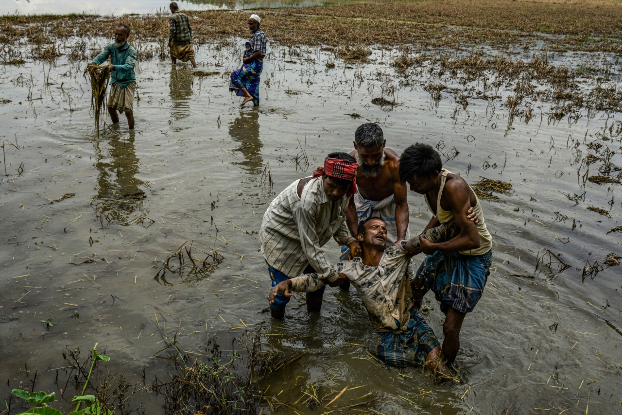 Distraught Indian farmers after paddy fields were destroyed by floods