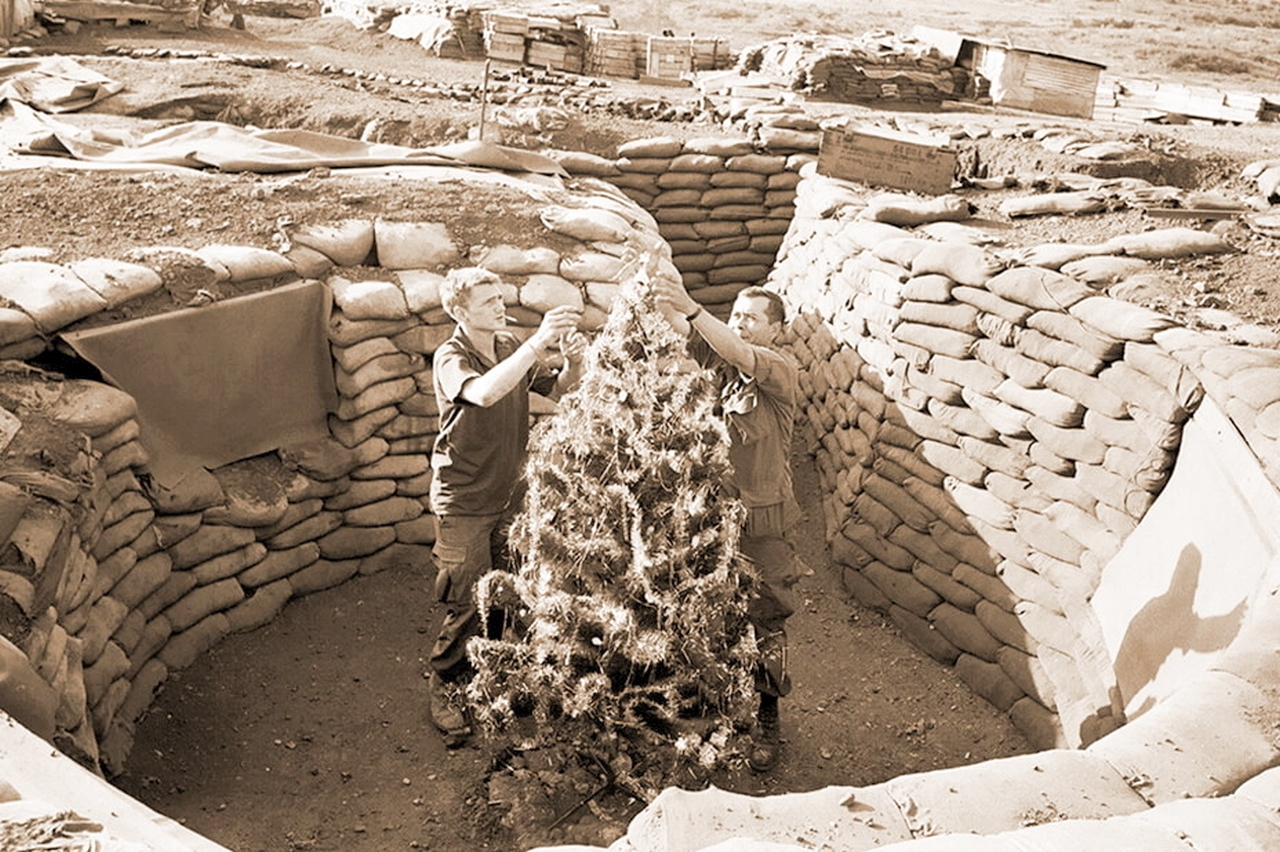 Soldiers Decorating Christmas Tree in a trench during Vietnam War 1969