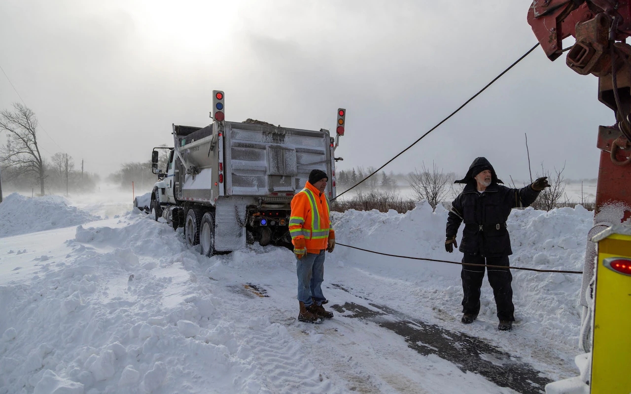 Stuck snow plough needs a tow in Canfield, Ontario in the devastating storm